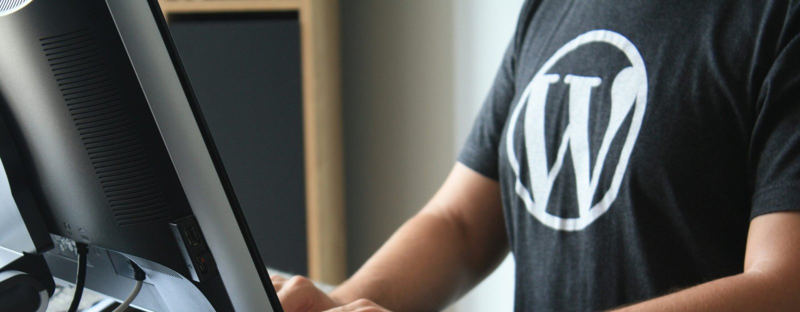 person in black and white t-shirt using computer